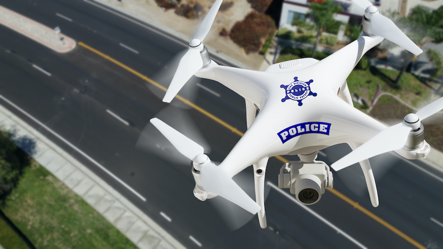 Police Unmanned Aircraft System, (UAS) Drone Flying Above A City Street.