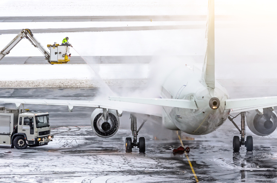 Ground crew provides de-icing. They are spraying the aircraft, which prevents the occurrence of frost.